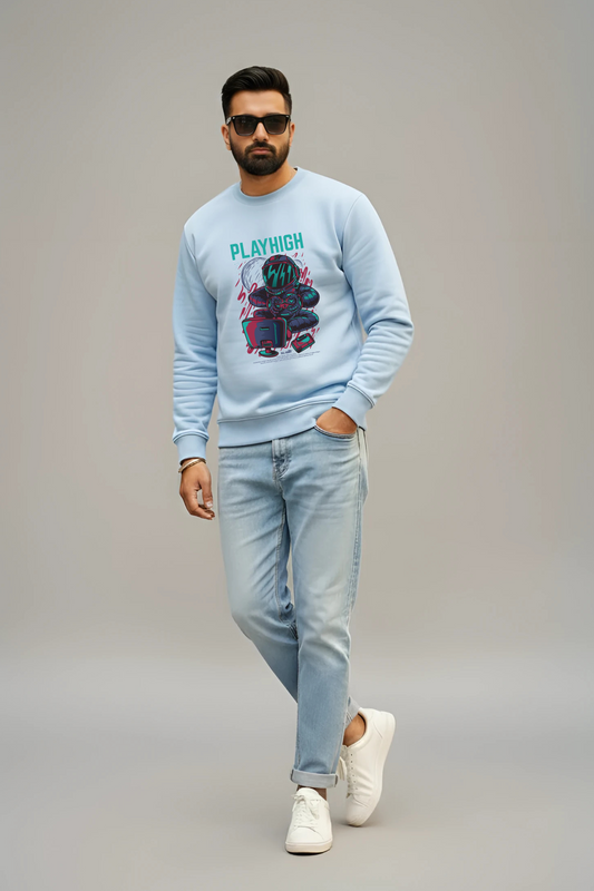 Man wearing a light blue sweatshirt with a graphic design, light blue jeans, and white sneakers on a gray background.