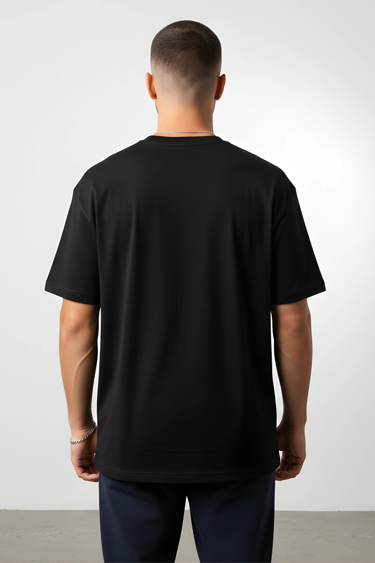 Person wearing a black t-shirt against a white background